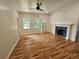 Bright living room featuring hardwood floors, a decorative fireplace, and plenty of natural light at 1497 Elizabeth Ln, East Point, GA 30344