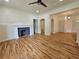 Spacious living room with beautiful hardwood floors and a decorative fireplace with white mantel at 1497 Elizabeth Ln, East Point, GA 30344