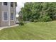 A view of a large backyard featuring healthy lawn and mature trees at 2625 Morningside Nw Trl, Kennesaw, GA 30144