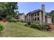 A large, grassy backyard features mature trees and landscaping at 2625 Morningside Nw Trl, Kennesaw, GA 30144