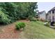 A partial view of a well-maintained backyard with pine straw and grass at 2625 Morningside Nw Trl, Kennesaw, GA 30144