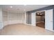Finished basement with custom shelving, tile floors and double door entry to another room at 2625 Morningside Nw Trl, Kennesaw, GA 30144