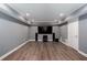 Finished basement media room boasts modern floors, TV, and recessed lighting at 2625 Morningside Nw Trl, Kennesaw, GA 30144