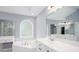 Light-filled bathroom boasts a corner tub, white cabinets, and ample counter space at 2625 Morningside Nw Trl, Kennesaw, GA 30144