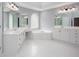 Bright bathroom featuring white cabinets, dual sinks, a garden tub, and tile floors at 2625 Morningside Nw Trl, Kennesaw, GA 30144