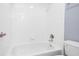 Bathroom tub and shower combination with white tiling and updated fixtures at 2625 Morningside Nw Trl, Kennesaw, GA 30144