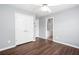 A bright bedroom features wood-look floors, pale blue walls, white trim and a ceiling fan at 2625 Morningside Nw Trl, Kennesaw, GA 30144