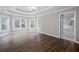 Spacious bedroom featuring hardwood floors, tray ceilings, and natural light from multiple windows at 2625 Morningside Nw Trl, Kennesaw, GA 30144