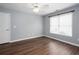 A bright bedroom features wood-look floors, pale blue walls, white trim, and a large window at 2625 Morningside Nw Trl, Kennesaw, GA 30144