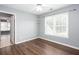Bedroom with two windows, wood flooring, ceiling fan, and view into other rooms at 2625 Morningside Nw Trl, Kennesaw, GA 30144