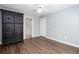 Bedroom features wood-look floors, pale blue walls, white trim, and access to the ensuite bathroom at 2625 Morningside Nw Trl, Kennesaw, GA 30144