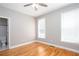Bright bedroom with hardwood floors, two windows, and a ceiling fan at 2625 Morningside Nw Trl, Kennesaw, GA 30144