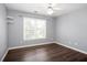 Comfortable bedroom with modern ceiling fan, wood flooring, and a large window at 2625 Morningside Nw Trl, Kennesaw, GA 30144