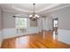 Elegant dining room with hardwood floors, decorative wainscoting, tray ceiling and access to the staircase at 2625 Morningside Nw Trl, Kennesaw, GA 30144