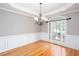 Formal dining room featuring hardwood floors, wainscoting, decorative ceilings, and a large window at 2625 Morningside Nw Trl, Kennesaw, GA 30144