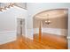 Elegant dining room featuring hardwood floors, wainscoting, decorative ceiling, and stylish chandelier at 2625 Morningside Nw Trl, Kennesaw, GA 30144
