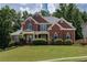 Charming two-story red brick home with well-manicured lawn and mature trees in a desirable neighborhood at 2625 Morningside Nw Trl, Kennesaw, GA 30144
