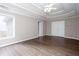 Spacious main bedroom with wood-look floors, white trim, and a large tray ceiling at 2625 Morningside Nw Trl, Kennesaw, GA 30144