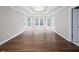 Spacious main bedroom with wood-look floors, white trim, and a large tray ceiling at 2625 Morningside Nw Trl, Kennesaw, GA 30144