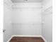 Walk-in closet featuring built-in shelving and wood floors at 2625 Morningside Nw Trl, Kennesaw, GA 30144