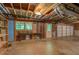 Unfinished basement features exposed ceiling, large garage door and window providing natural light at 3957 Woodland Cir, Conyers, GA 30013