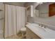 Cozy bathroom featuring shower with curtain, and a white vanity at 3957 Woodland Cir, Conyers, GA 30013