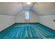 Cozy bedroom with angled ceilings, carpet floors, and a window for natural light at 3957 Woodland Cir, Conyers, GA 30013