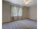 Spacious bedroom with neutral carpet, ceiling fan, and large window for natural light at 3957 Woodland Cir, Conyers, GA 30013