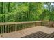 A wood planked deck provides a tranquil outdoor space surrounded by lush greenery at 3957 Woodland Cir, Conyers, GA 30013