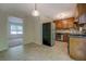 A kitchen with wood cabinets, an adjacent dining area, and lots of natural light at 3957 Woodland Cir, Conyers, GA 30013