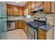 This kitchen features stainless steel appliances, wood cabinets, and neutral backsplash at 3957 Woodland Cir, Conyers, GA 30013