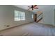 This brightly lit living room shows neutral walls, a front door, and a staircase to the second floor at 3957 Woodland Cir, Conyers, GA 30013