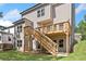 Backyard of the home featuring a wooden deck with stairs, a spacious yard, and privacy trees at 419 Crestmont Ln, Canton, GA 30114
