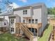 Backyard view of the home with a wooden deck, stairs leading to the yard, and ample green space at 419 Crestmont Ln, Canton, GA 30114