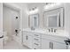Modern bathroom featuring double vanity with white cabinets, and modern fixtures at 419 Crestmont Ln, Canton, GA 30114