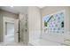 Modern bathroom with soaking tub, tiled shower, and bright natural light at 419 Crestmont Ln, Canton, GA 30114