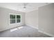 Cozy bedroom featuring neutral walls, plush carpeting, and a bright window view at 419 Crestmont Ln, Canton, GA 30114