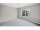 Bright bedroom featuring neutral walls, plush carpeting, and a bright window view at 419 Crestmont Ln, Canton, GA 30114
