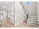 Bright entryway features wood-look flooring, staircase, and access to the kitchen and outdoor patio at 419 Crestmont Ln, Canton, GA 30114
