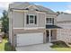 Charming two-story home featuring brick and siding, a two-car garage, and a covered front porch at 419 Crestmont Ln, Canton, GA 30114