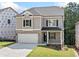 Charming two-story home with brick accents, a two-car garage, and a covered front porch at 419 Crestmont Ln, Canton, GA 30114