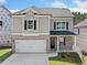 Charming two-story home featuring brick and siding, a two-car garage, and a well-manicured front yard at 419 Crestmont Ln, Canton, GA 30114