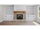 Cozy fireplace with brick surround, custom built-ins and wood mantel at 419 Crestmont Ln, Canton, GA 30114
