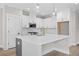 Spacious kitchen features white cabinets, an island, pendant lighting, and stainless steel appliances at 419 Crestmont Ln, Canton, GA 30114