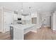 Modern kitchen features an island, stainless steel appliances, and access to the home's entryway at 419 Crestmont Ln, Canton, GA 30114