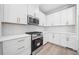 Bright kitchen features quartz countertops, stainless steel appliances, and white cabinets at 419 Crestmont Ln, Canton, GA 30114