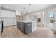 Spacious kitchen with a grey island, white cabinets, stainless appliances, and an open floor plan at 419 Crestmont Ln, Canton, GA 30114