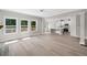 Bright, open-concept living space with hardwood floors and a view into the modern kitchen at 419 Crestmont Ln, Canton, GA 30114