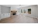 Spacious living room featuring fireplace, custom built-ins, and natural light at 419 Crestmont Ln, Canton, GA 30114