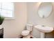 Cozy half-bathroom featuring a pedestal sink, an oval mirror, and neutral walls, creating a serene and minimalist space at 5025 Bishops Row Row, Austell, GA 30106